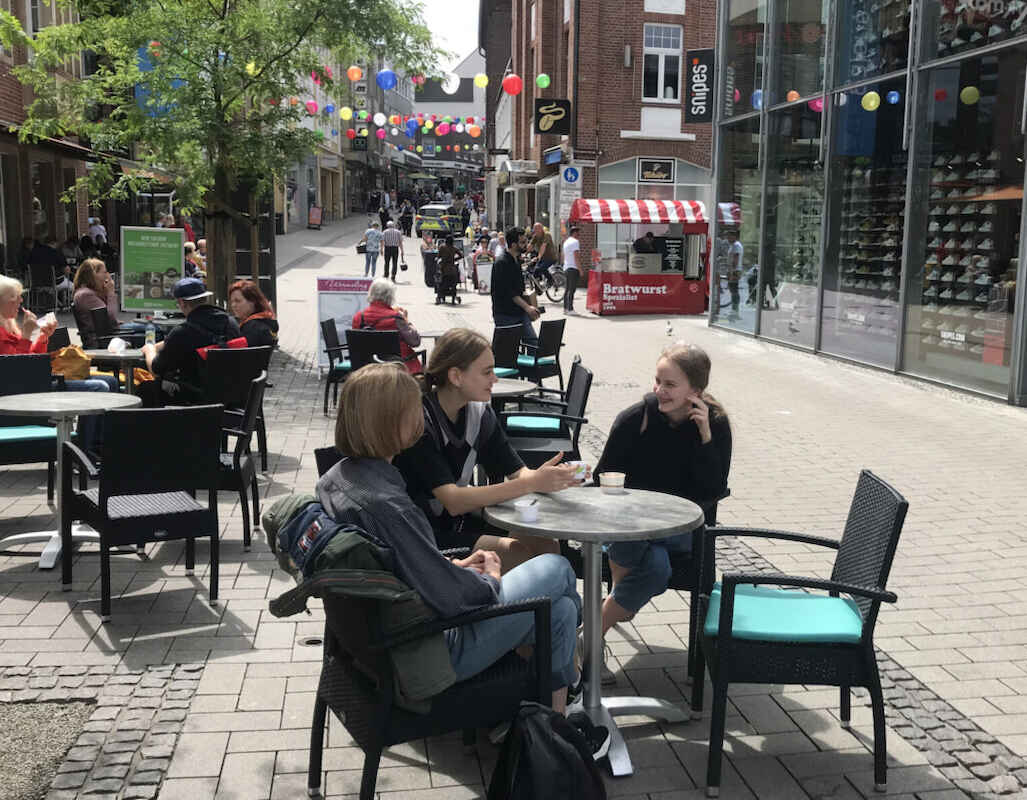 Polina, Daria und Kateryna besprechen ihre Zukunftspläne in einem Eiscafé in der Innenstadt, Juli 2022